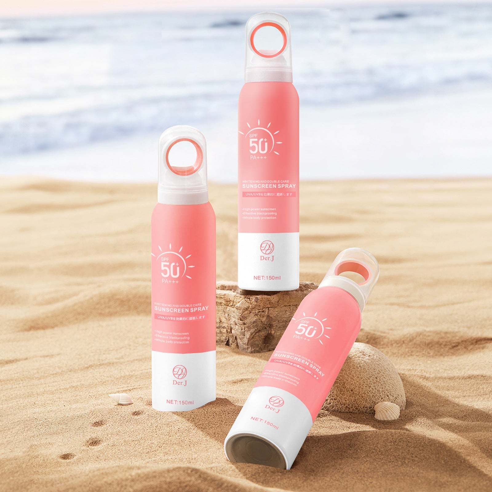 Moisturizing skin care isolation spray in pink bottles on sandy beach with ocean background.